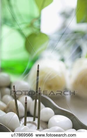 Close-up of burning incense sticks with white pebbles in a bowl View Large Photo Image Stock Photograph - Close-up of burning incense sticks with white pebbles in a bowl. Fotosearch