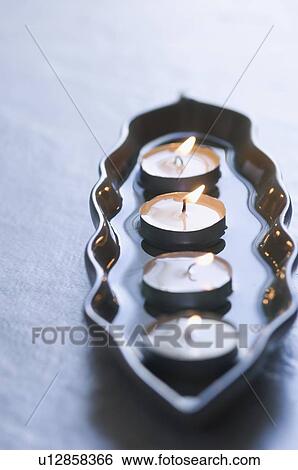 Close-up of four aromatherapy candles burning in a tray View Large Photo Image Stock Photograph - Close-up of four aromatherapy candles burning in a tray. Fotosearch