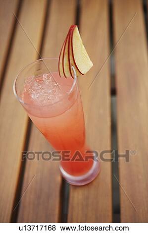 High angle view of a glass of apple juice on a bench View Large Photo Image Stock Photo - High angle view of a glass of apple juice on a bench. Fotosearch