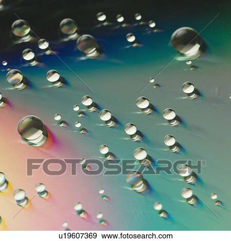 Close-up of water drops on a multi-colored surface View Large Photo Image Stock Photo - Close-up of water drops on a multi-colored surface. Fotosearch