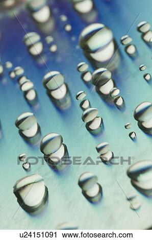 Stock Image - Close-up of water drops on a surface. Fotosearch