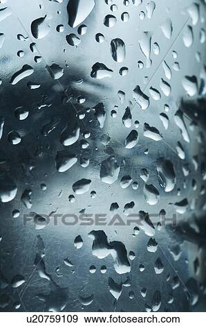 Stock Photo - Close-up of water drops on a surface. Fotosearch