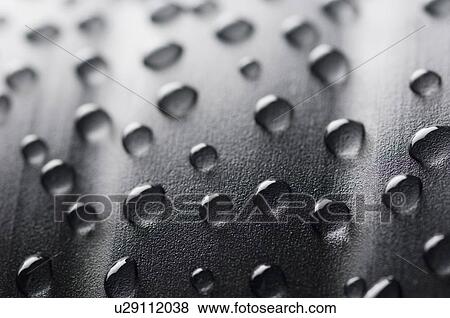Stock Photo - Close-up of water drops on a surface. Fotosearch