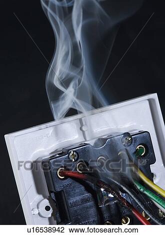 Stock Image - Smoke coming out from a switchboard. Fotosearch