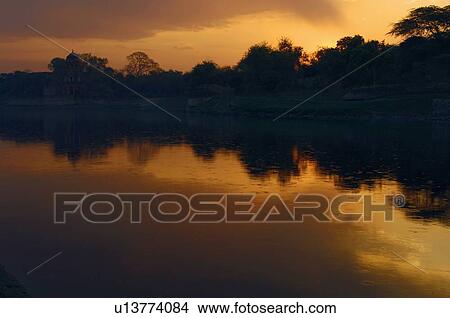 Reflection of trees in the river View Large Photo Image Picture - Reflection of trees in the river. Fotosearch