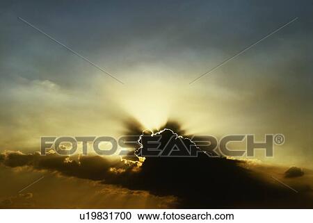 Sun setting behind dark clouds View Large Photo Image Stock Image - Sun setting behind dark clouds. Fotosearch