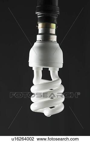 Stock Image - Close-up of a lit compact fluorescent light bulb. Fotosearch
