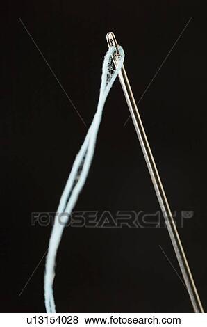 Stock Photo - Close-up of a needle and a thread. Fotosearch