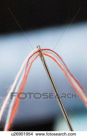 Picture - Close-up of a needle and threads. Fotosearch