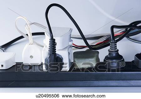 Close-up of electric plugs plugged into an extension socket View Large Photo Image Stock Photograph - Close-up of electric plugs plugged into an extension socket. Fotosearch