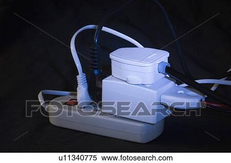 Stock Photography - Close-up of electric plugs plugged into an extension socket. Fotosearch