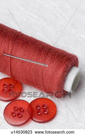 Close-up of red buttons and a needle with a spool of red thread View Large Photo Image Stock Image - Close-up of red buttons and a needle with a spool of red thread. Fotosearch