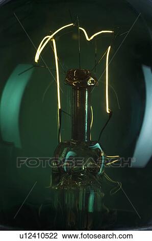 Close-up of the lit filament of a bulb View Large Photo Image Stock Image - Close-up of the lit filament of a bulb. Fotosearch