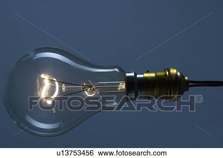 Close-up of the lit filament of a bulb View Large Photo Image Stock Photograph - Close-up of the lit filament of a bulb. Fotosearch