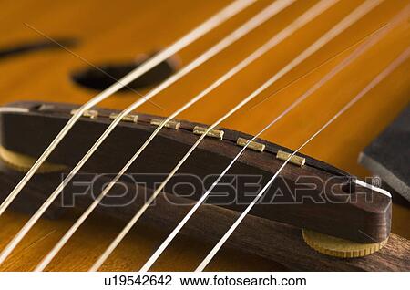 Stock Image - Close-up of strings of a guitar. Fotosearch