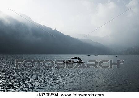 Boats in a lake View Large Photo Image Picture - Boats in a lake. Fotosearch