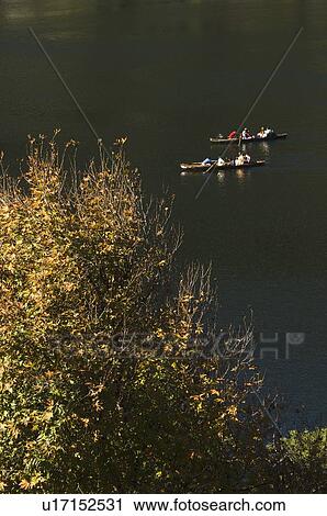 Stock Image - Group of people boating in a lake. Fotosearch