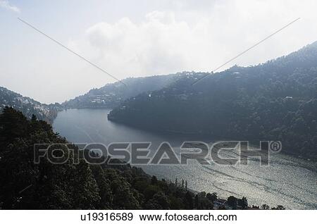 Stock Photo - High angle view of a river flowing between mountains. Fotosearch