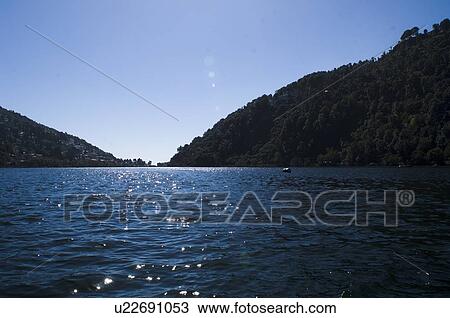 Mountains overlooking a lake View Large Photo Image Stock Image - Mountains overlooking a lake. Fotosearch