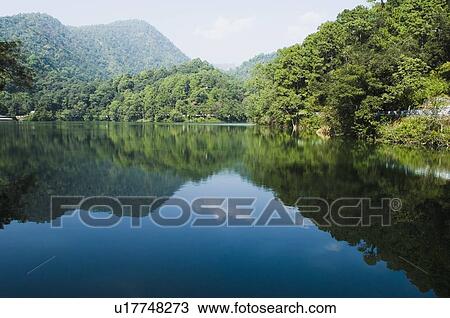 Stock Image - Mountains surrounding a lake. Fotosearch