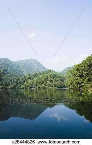 Mountains surrounding a lake View Large Photo Image Stock Photograph - Mountains surrounding a lake. Fotosearch
