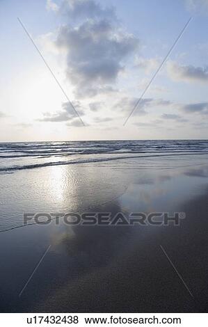 Stock Photo - Reflection of clouds in the sea. Fotosearch