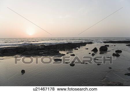 Stock Photo - Sunset over the sea. Fotosearch