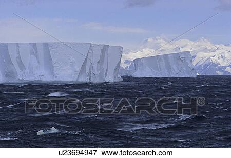 Stock Photo - Tabular icebergs with Admiralty Mountains Range in background. Nearby Cape Adare, Ross Sea, Antarctica. Fotosearch