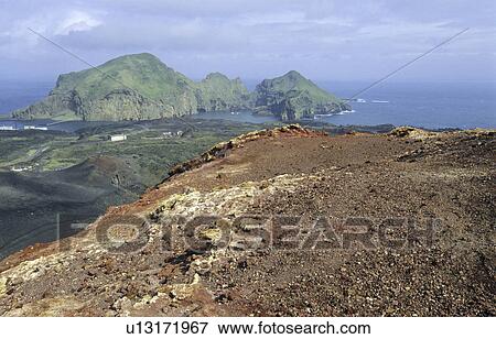 View from the Volcano Eldfell down to the settlement Heimaey. Vestmannaeyjar Islands, Southern Iceland View Large Photo Image Stock Photo - View from the Volcano Eldfell down to the settlement Heimaey. Vestmannaeyjar Islands, Southern Iceland. Fotosearch