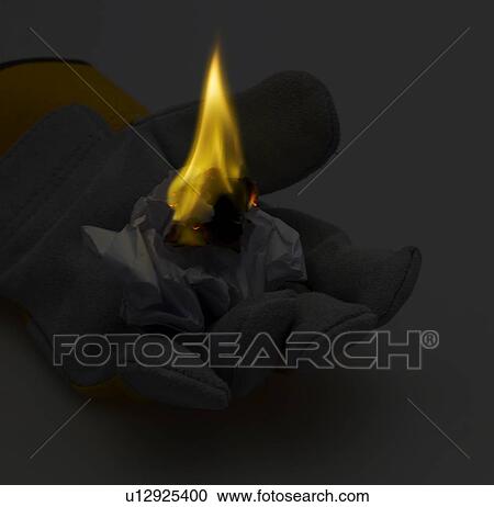 Stock Image - Paper Ball Burning on Glove. Fotosearch
