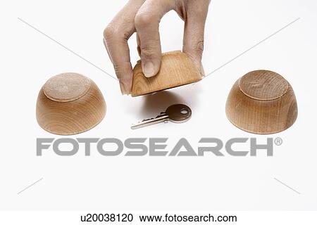 Stock Image - Person Playing Shell Game. Fotosearch
