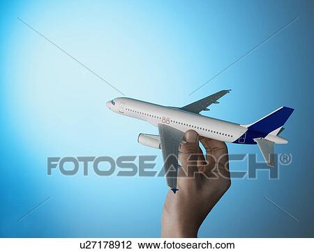 Stock Image - Person's Hand Holding Model Aeroplane. Fotosearch