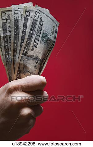 Person's hand holding US dollar notes (close-up) View Large Photo Image Stock Photo - Person's hand holding US dollar notes (close-up). Fotosearch