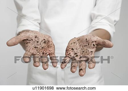 Stock Photo - Soil on person's hands (mid section). Fotosearch