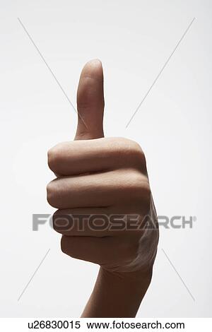 Stock Photography - Woman giving thumbs up (close-up). Fotosearch