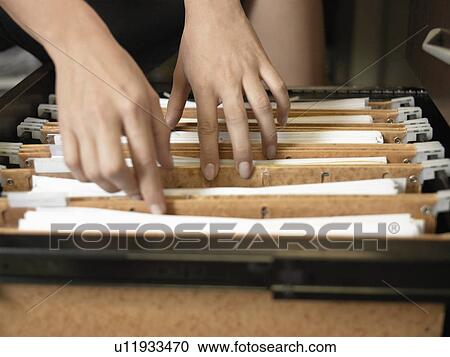 Woman going through files (close-up) View Large Photo Image Stock Image - Woman going through files (close-up). Fotosearch