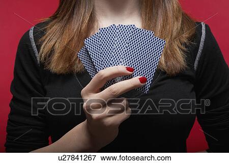Stock Photo - Woman holding hand of cards (close-up). Fotosearch