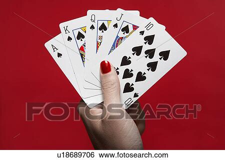 Stock Photograph - Woman's hand holding 'Royal Flush' hand of cards. Fotosearch