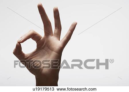 Stock Image - Woman's hand making 'OK' sign (close-up). Fotosearch