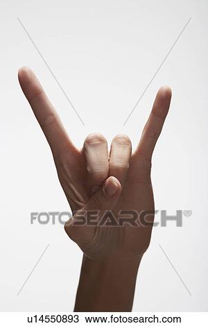 Stock Image - Woman's hand making 'Rock and Roll' sign (close-up). Fotosearch