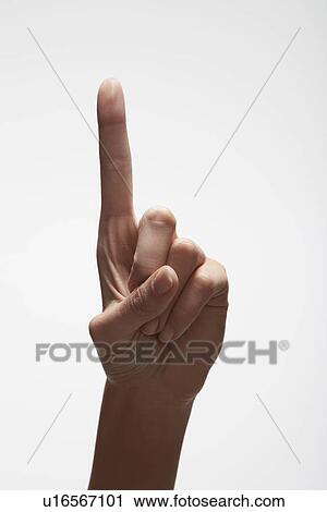 Stock Image - Woman's hand pointing up (close-up). Fotosearch