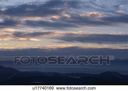 Stock Photo - Evening Glow And A Mountain Range. Fotosearch