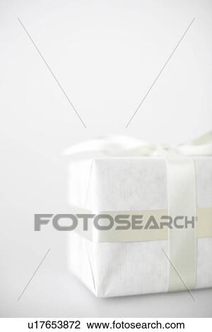 Gift in white packaging (close-up) View Large Photo Image Stock Image - Gift in white packaging (close-up). Fotosearch