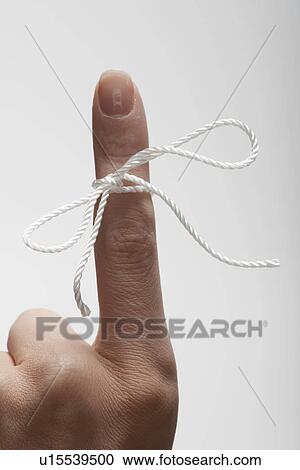 String tied on woman's index finger (close-up) View Large Photo Image Stock Image - String tied on woman's index finger (close-up). Fotosearch
