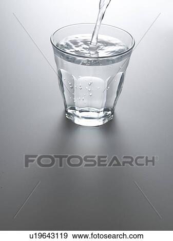 Stock Photo - Water Being Pouring in Glass. Fotosearch
