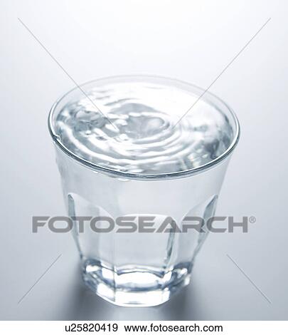 Waterdrops Falling on Full Glass of Water View Large Photo Image Stock Photo - Waterdrops Falling on Full Glass of Water. Fotosearch