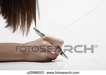 Stock Image - Woman's hand holding pen (close-up). Fotosearch
