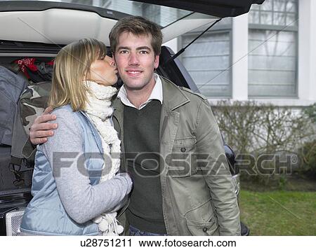 Couple in front of packed car View Large Photo Image Stock Image - Couple in front of packed car. Fotosearch