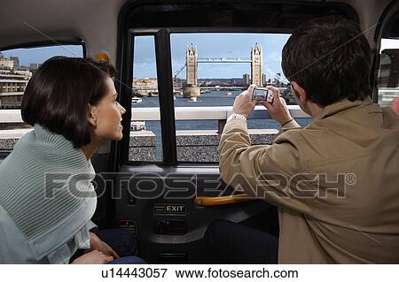 Couple in taxi, view of Tower Bridge View Large Photo Image Stock Photo - Couple in taxi, view of Tower Bridge. Fotosearch
