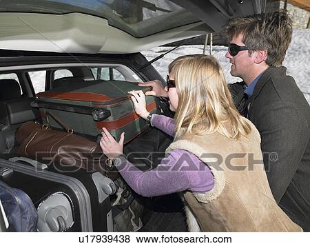 Couple packing car View Large Photo Image Stock Photo - Couple packing car. Fotosearch